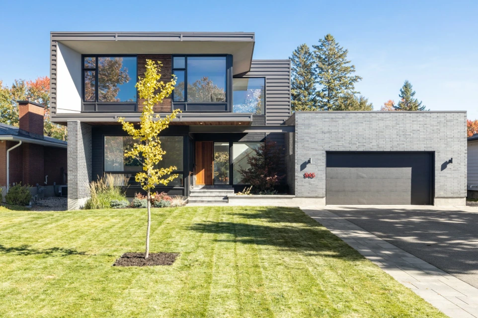a modern house design with a tree in the front yard